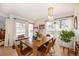 Bright dining room with a wooden table, pendant lighting, and ample natural light at 661 Snowberry St, Longmont, CO 80503