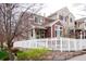 Charming multi-story home with a white picket fence and beautiful landscaping, perfect for families at 661 Snowberry St, Longmont, CO 80503