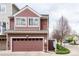 Two-story house with a brown garage and tidy landscaping at 661 Snowberry St, Longmont, CO 80503