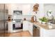 Modern kitchen with stainless steel appliances, granite countertops, and white cabinetry at 661 Snowberry St, Longmont, CO 80503