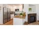 Well-equipped kitchen featuring stainless steel appliances, granite countertops, and a charming fireplace at 661 Snowberry St, Longmont, CO 80503