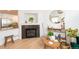 Cozy living room boasts hardwood floors, fireplace, and modern decor, creating a comfortable and inviting space at 661 Snowberry St, Longmont, CO 80503
