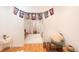Well-lit living room with hardwood floors, white rug, and a door that leads to another room at 661 Snowberry St, Longmont, CO 80503
