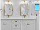 Elegant bathroom with double vanity, quartz countertops, and gold fixtures at 1403 Yates St, Denver, CO 80204