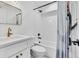 Clean bathroom with white subway tile and gold fixtures at 1403 Yates St, Denver, CO 80204