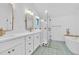 Spa-like bathroom with a freestanding soaking tub, double vanity, and walk-in shower at 1403 Yates St, Denver, CO 80204