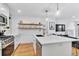 Modern kitchen island with white cabinets and quartz countertops at 1403 Yates St, Denver, CO 80204