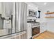 Modern kitchen with stainless steel appliances and white cabinetry at 1403 Yates St, Denver, CO 80204