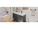 Bathroom with a double sink vanity and wood floors at 2601 N Clayton St, Denver, CO 80205
