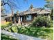 Charming brick home with a well-manicured lawn and inviting front porch at 2601 N Clayton St, Denver, CO 80205