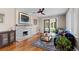 Cozy living room featuring hardwood floors, fireplace, and a sliding door that opens up to an outdoor living space at 2601 N Clayton St, Denver, CO 80205