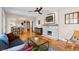 Open-concept living room with hardwood floors, fireplace, and dining area at 2601 N Clayton St, Denver, CO 80205