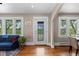 Bright living room showcasing gleaming hardwood floors and large windows for natural light and outdoor views at 2601 N Clayton St, Denver, CO 80205