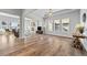 Open-concept living room featuring natural light, hardwood floors, and an inviting fireplace at 8765 S Quemoy St, Aurora, CO 80016