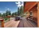Large wooden deck with an outdoor dining table, porch swings and lovely mountain views at 10381 Hondah Dr, Littleton, CO 80127