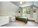 Bedroom featuring peaked ceiling, a ceiling fan, and a window providing natural light at 10381 Hondah Dr, Littleton, CO 80127