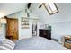 Bedroom with vaulted ceiling and a skylight, a wood closet door, and wooden floating shelves at 10381 Hondah Dr, Littleton, CO 80127