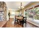 Dining area featuring natural light, a table with four chairs, and a view of the trees and landscape at 10381 Hondah Dr, Littleton, CO 80127