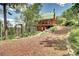 Picturesque cabin featuring a unique barrel sauna, outdoor shower, and wooden exterior with lush surroundings at 10381 Hondah Dr, Littleton, CO 80127