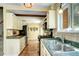 Traditional kitchen featuring stainless steel appliances, wood cabinets, and tiled backsplash at 10381 Hondah Dr, Littleton, CO 80127