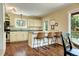 Bright kitchen features a breakfast bar, a window, and lots of natural light at 10381 Hondah Dr, Littleton, CO 80127