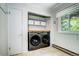 Well-organized laundry room with shelving, front loading washer and dryer, and a window for natural light at 10381 Hondah Dr, Littleton, CO 80127