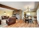 Spacious living room with stone fireplace, an area rug, dining area, and lots of natural light at 10381 Hondah Dr, Littleton, CO 80127