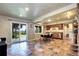 Open living space with walkout to patio, slate floor, breakfast nook and full kitchen at 10381 Hondah Dr, Littleton, CO 80127