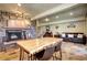 Open concept living room with fireplace and dining table perfect for entertaining at 10381 Hondah Dr, Littleton, CO 80127