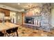 Living room featuring a stone fireplace, wood floors, an american flag and a bar area at 10381 Hondah Dr, Littleton, CO 80127