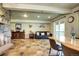 Open concept living room boasts slate floors, a beautiful stone fireplace and walk out to a patio at 10381 Hondah Dr, Littleton, CO 80127
