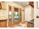 Cozy mud room with natural light, bench seat, closet, and decorative hooks for coats and bags at 10381 Hondah Dr, Littleton, CO 80127