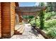 Inviting outdoor patio space with stone flooring, wooden pergola, string lights, seating, and access to the main home at 10381 Hondah Dr, Littleton, CO 80127
