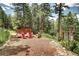 Picturesque outdoor seating area with a fire pit, rustic wood storage, and scenic natural surroundings at 10381 Hondah Dr, Littleton, CO 80127
