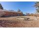 Large backyard showcasing a brick home, shed, and a garden bed, offering ample space for recreation at 15303 E 10Th Ave, Aurora, CO 80011