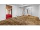 Spacious basement featuring carpeted floors, access to other rooms, and a closet with mirrored doors at 15303 E 10Th Ave, Aurora, CO 80011