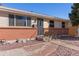 Traditional home with a brick foundation and a secure, decorative wrought iron front door at 15303 E 10Th Ave, Aurora, CO 80011
