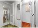 View of hallway with folding closet doors and access to the bathroom with tiled floors at 15303 E 10Th Ave, Aurora, CO 80011