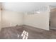 Spacious, carpeted living room with a unique half wall feature and natural light at 15303 E 10Th Ave, Aurora, CO 80011