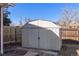 View of backyard shed providing additional storage space and complementing the fenced yard at 15303 E 10Th Ave, Aurora, CO 80011