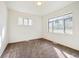 Bedroom featuring carpet flooring, natural light from windows, and a modern ceiling light at 3232 S Elm St, Denver, CO 80222