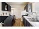 Modern kitchen with dark cabinets, white countertops, stainless steel appliances, and hardwood floors at 3232 S Elm St, Denver, CO 80222