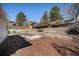 Backyard with layered landscaping, mature trees, a small playhouse and outdoor recreation space at 9561 W Wesley Dr, Lakewood, CO 80227