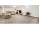 Finished basement with a plush sectional sofa, TV, exercise bike and entertainment, and neutral carpet at 9561 W Wesley Dr, Lakewood, CO 80227