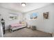 Bright bedroom features two windows and stylish decor, creating a cozy and inviting space at 9561 W Wesley Dr, Lakewood, CO 80227