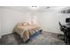 Bedroom setup with a bed and a desk, ideal for a home office, with carpet and white walls at 9561 W Wesley Dr, Lakewood, CO 80227
