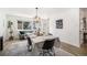 Bright dining room with modern light fixture, wood floors, and stylish decor at 9561 W Wesley Dr, Lakewood, CO 80227