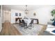 Bright dining room with modern light fixture, wood floors, and stylish decor at 9561 W Wesley Dr, Lakewood, CO 80227