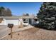 Charming single-story home featuring a well-manicured yard and an attached two-car garage at 9561 W Wesley Dr, Lakewood, CO 80227