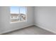Neutral-toned bedroom with a large window overlooking the neighborhood at 14283 Currant St, Broomfield, CO 80020